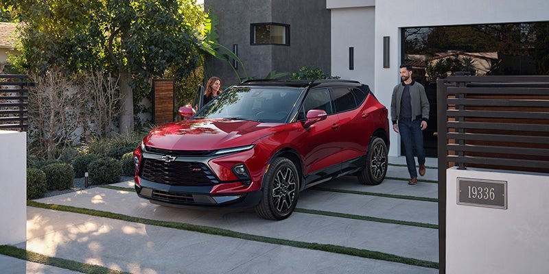 A red 2024 Chevy Blazer parked in a driveway.