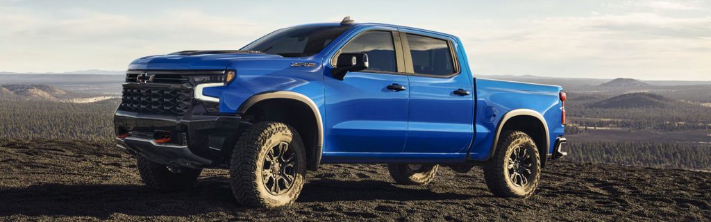 Blue Chevrolet Silverado ZR2 pickup truck parked on a scenic mountain landscape
