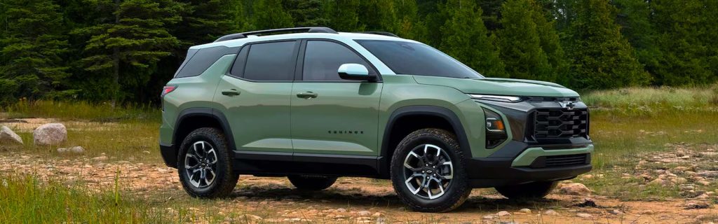 Green Chevrolet Equinox SUV parked on a rocky forest trail
