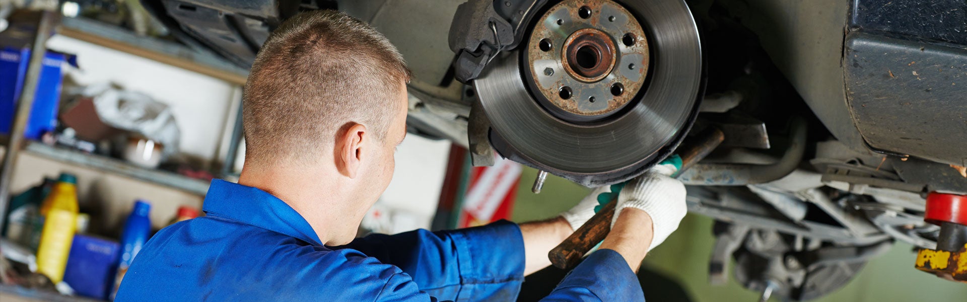 GM Technician Working On Brake